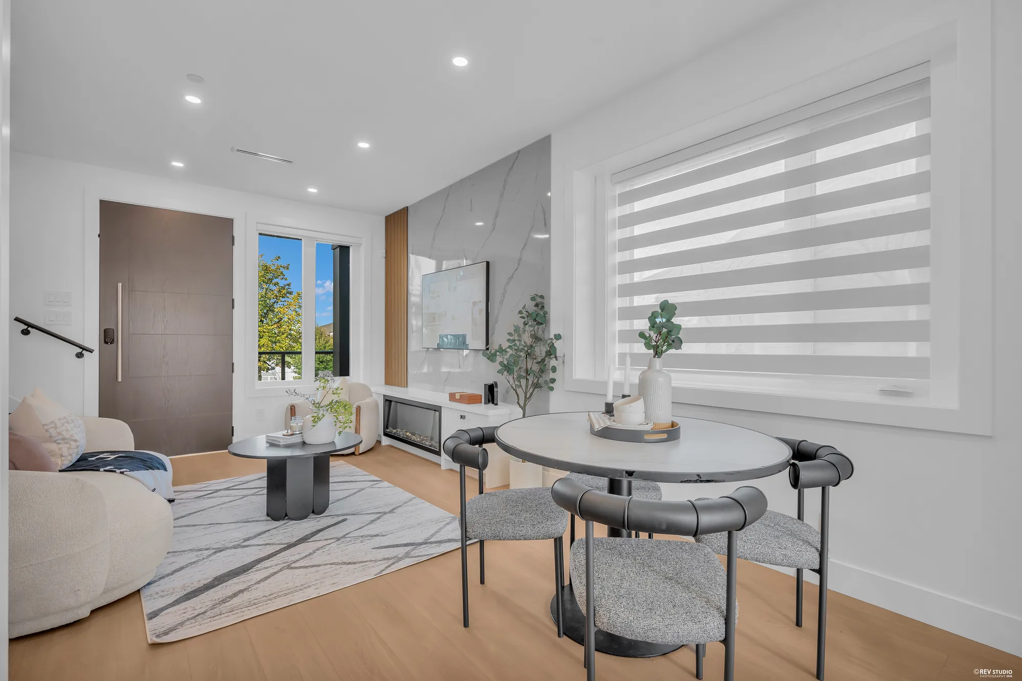 The dining area from the living room, the front door on the left, the kitchen beyond