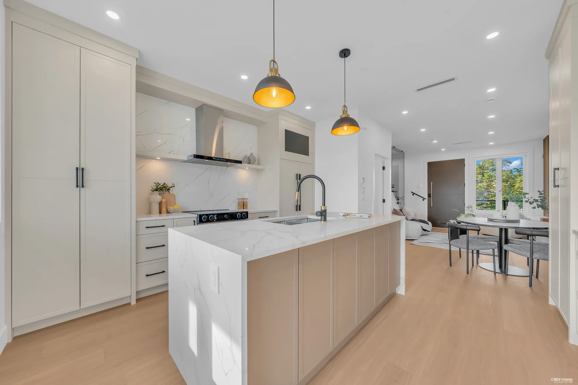 The kitchen and the dining area from the back door, the pendants over the island