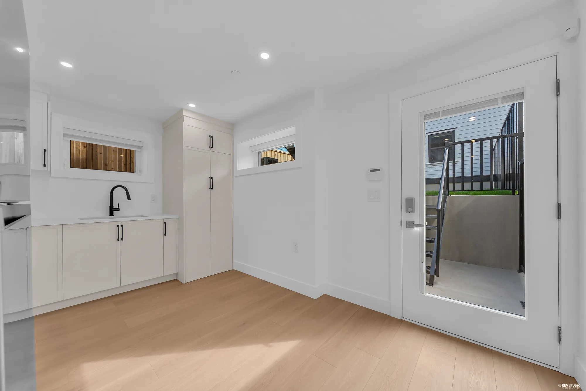 The lower kitchen with its own glazed door to the patio and the stair up